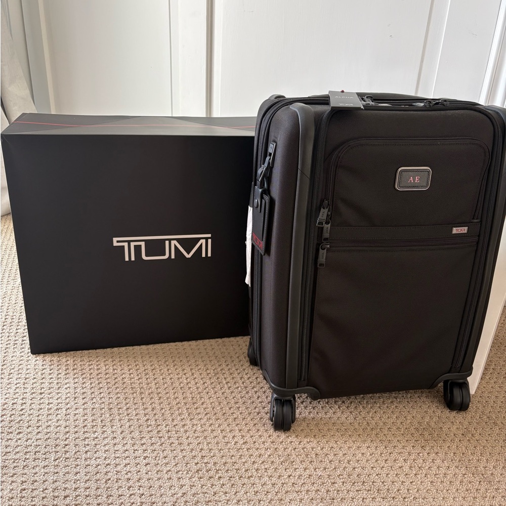 Brand New TUMI Black Rolling Suitcase with tags attached.
